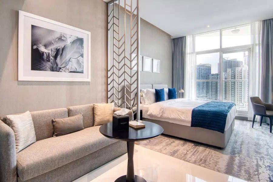 A completed Montroyal apartment — living area, bedroom and floor-to-ceiling windows over the Dubai skyline